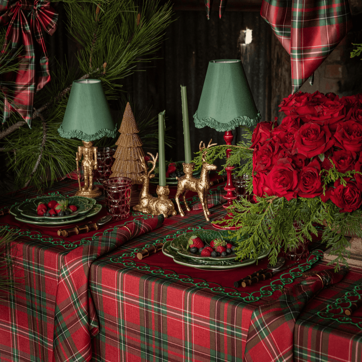 Red Tartan Christmas table styled with Red Tartan table cloth, gold nutcracker lamp and olive ruffle lamp shade