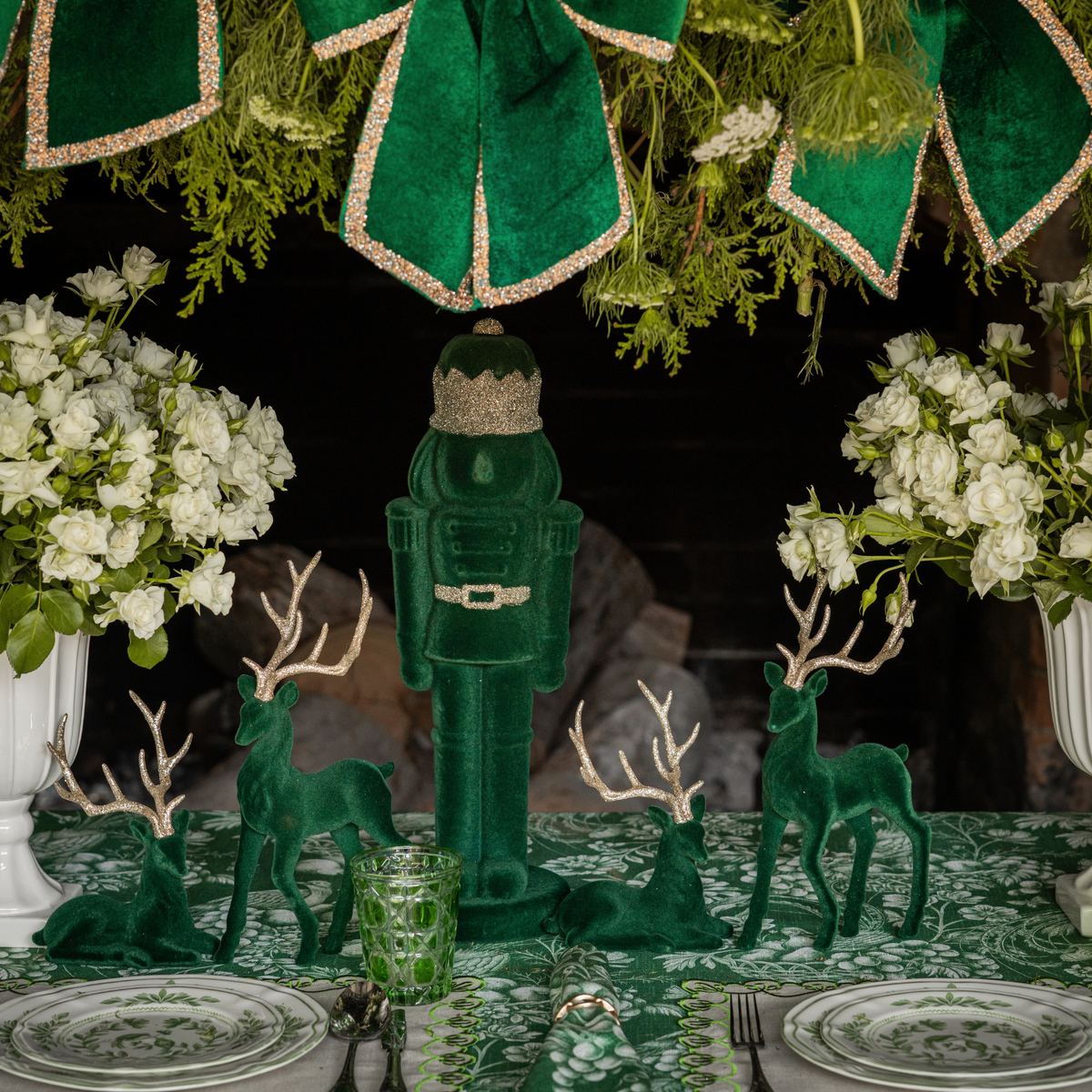 Green Toile Christmas table styled with dark green velvet nutcracker and dark green velvet reindeer