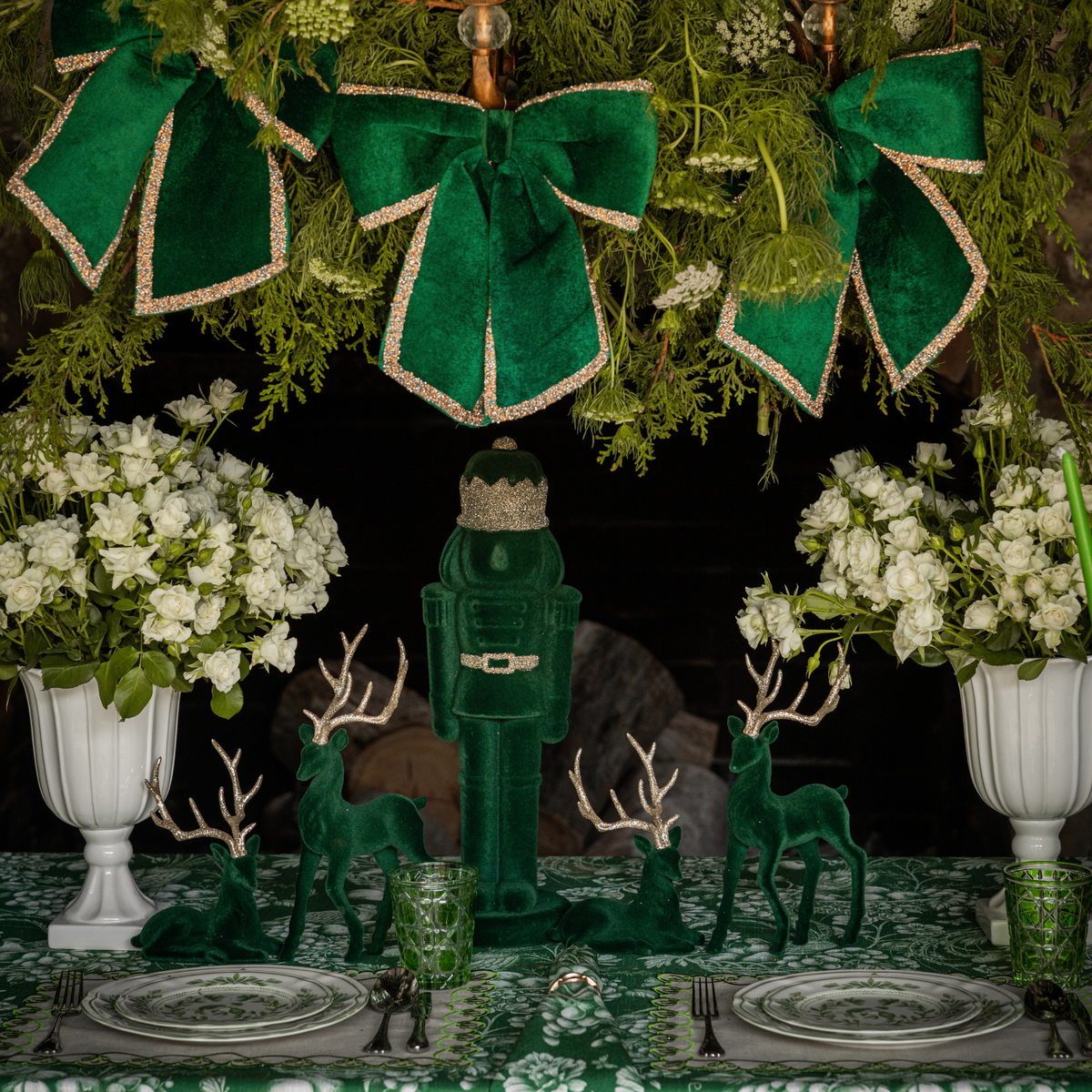 Green Toile Christmas table styled with dark green velvet nutcracker, green velvet glitter trim bows and dark green velvet reindeer