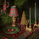 Red Tartan Christmas table styled with gold nutcracker lamp, Red Tartan ruffle lamp shade and dark brown rattan Christmas trees