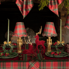 Red Tartan Christmas table styled with gold nutcracker lamp, Red Tartan ruffle lamp shade and burgundy velvet reindeer