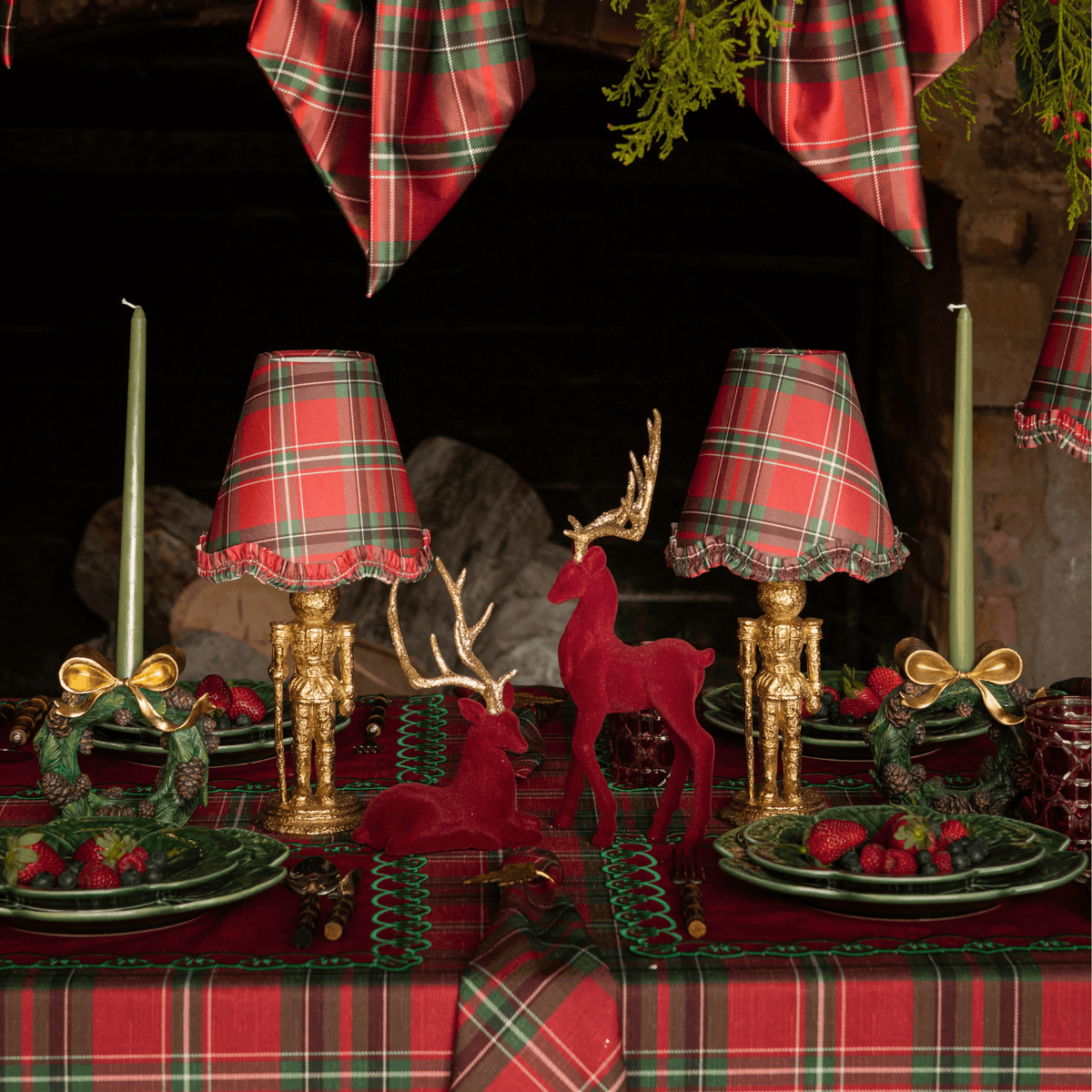 Red Tartan Christmas table styled with gold nutcracker lamp, Red Tartan ruffle lamp shade and burgundy velvet reindeer