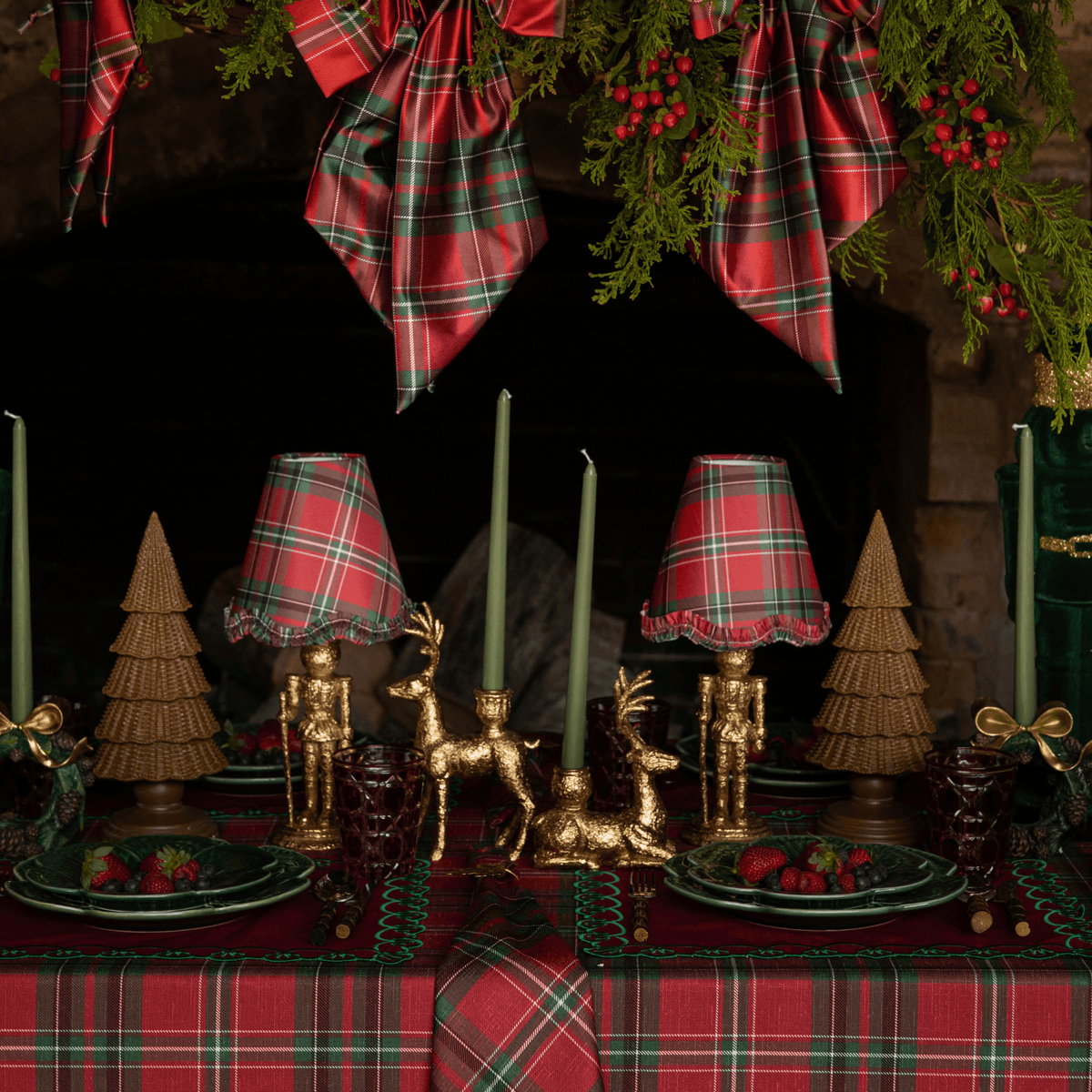 Red Tartan Christmas table styled with gold nutcracker lamp, Red Tartan ruffle lamp shade and dark brown rattan Christmas trees