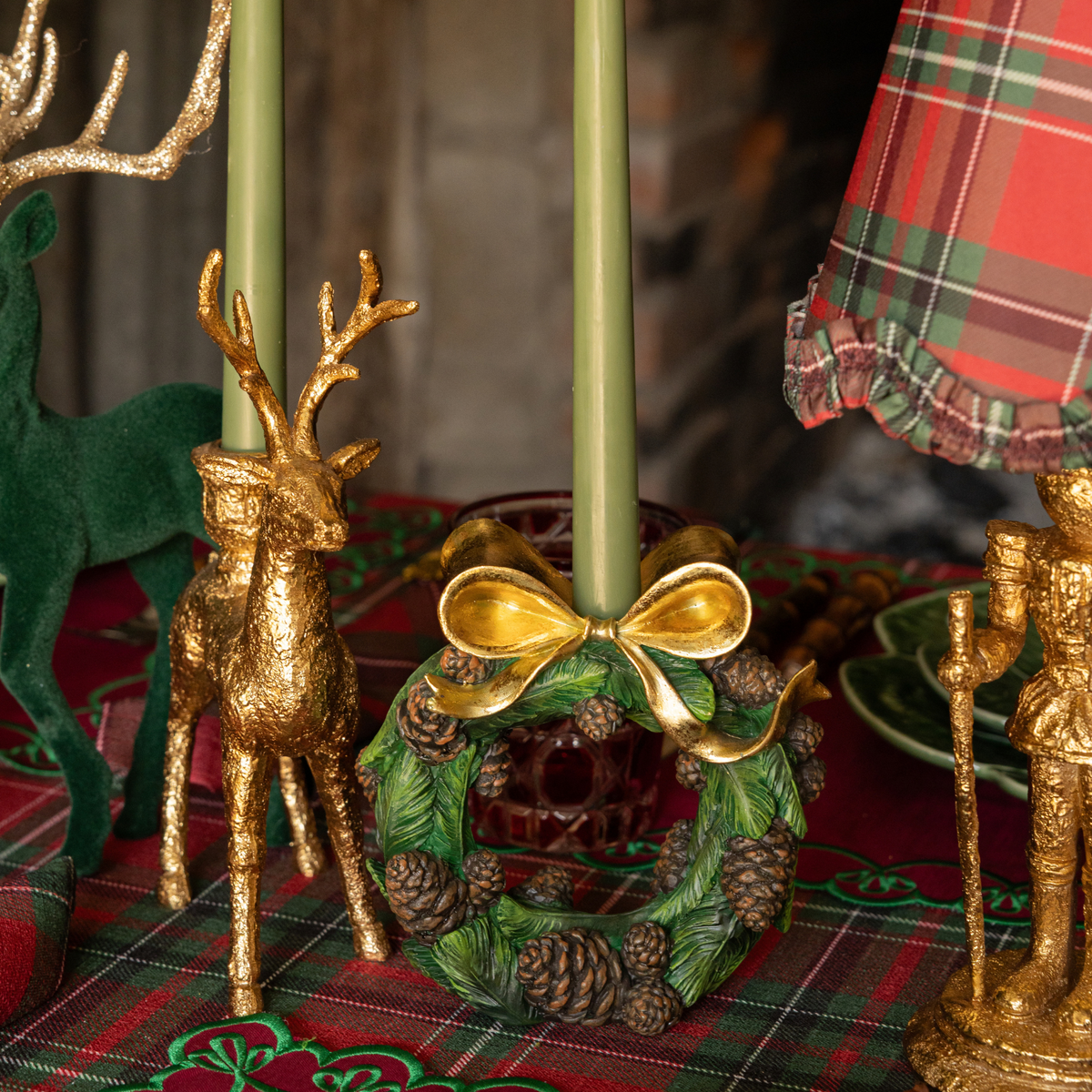 Red Tartan Christmas table styled with gold deer candle holders and pinecone wreath candle holders