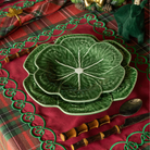 Red Tartan Christmas table styled with green cabbage plates, red placemats with green embroidery and gold leaf napkin rings