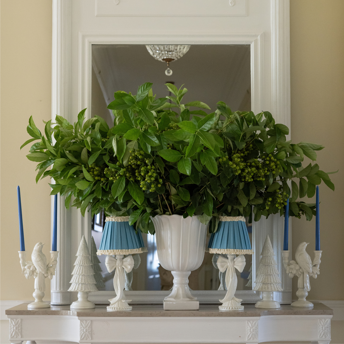 Blue Hydrangea Christmas table styled with white bow lamp, Audrey sky blue and cream shade and white rattan Christmas trees