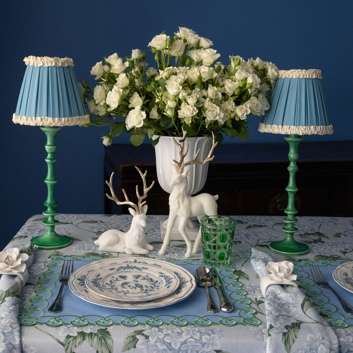 Blue Hydrangea Christmas table styled with emerald lamp base, Audrey sky blue and cream shade and cream velvet reindeer