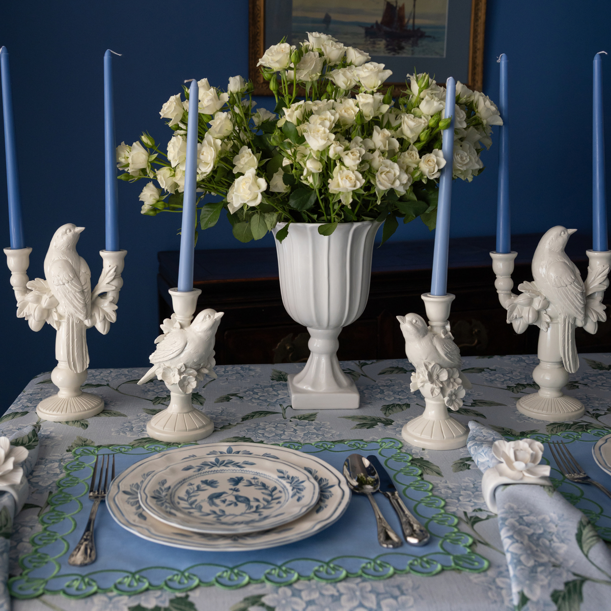 Blue Hydrangea Christmas table styled with white bird double candle holder, white bird candle holders and pale blue taper candles