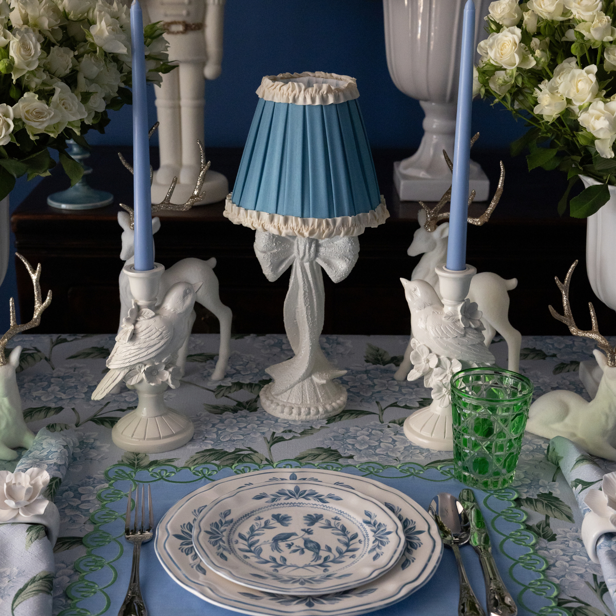 Blue Hydrangea Christmas table styled with white bow lamp, Audrey sky blue and cream shade and white bird candle holders