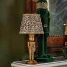 Green and Black Plaid Christmas table styled with gold nutcracker lamp and dark green velvet nutcracker