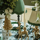 Green and Black Plaid Christmas table styled with gold Christmas tree, gold deer candle holders and olive ruffle lamp shade