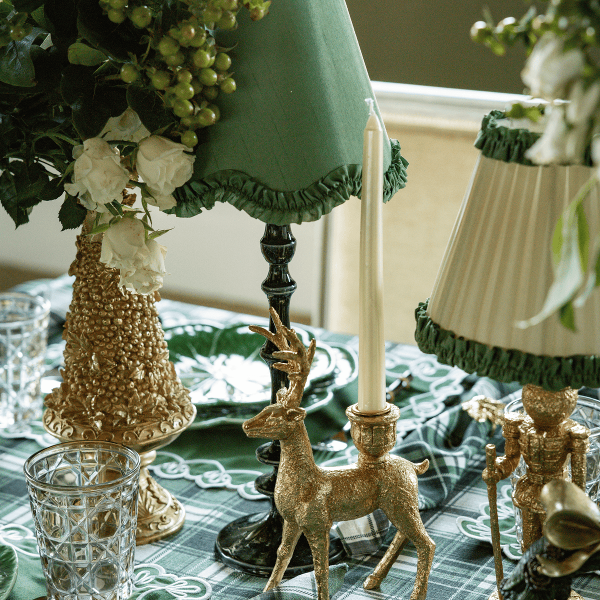 Green and Black Plaid Christmas table styled with gold Christmas tree, gold deer candle holders and olive ruffle lamp shade