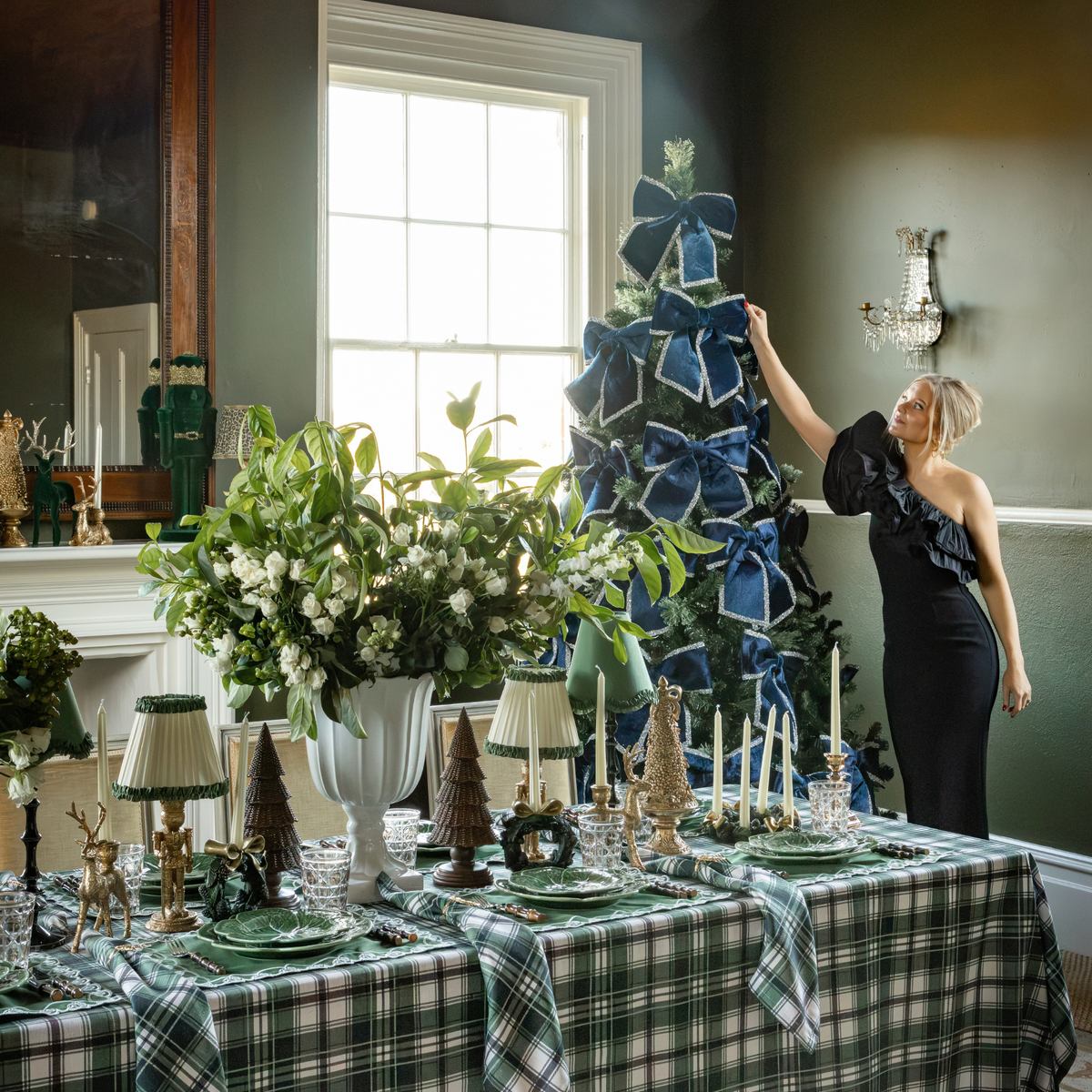 Green and Black Plaid Christmas table styled with navy velvet glitter trim bows and Green and Black Plaid table cloth