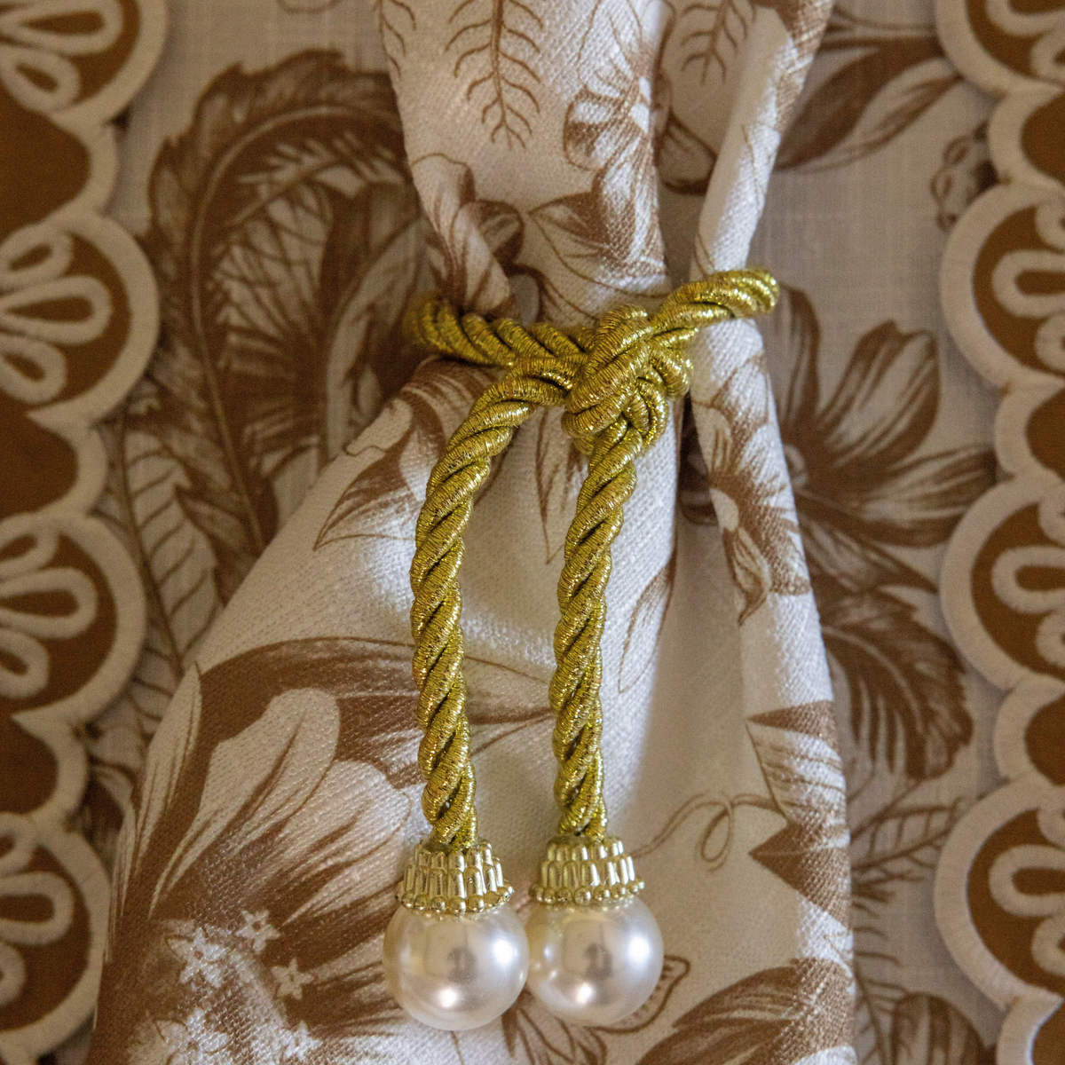 Gold Toile Christmas table styled with pearl napkin rings, Gold Toile napkins and gold placemats with ivory embroidery
