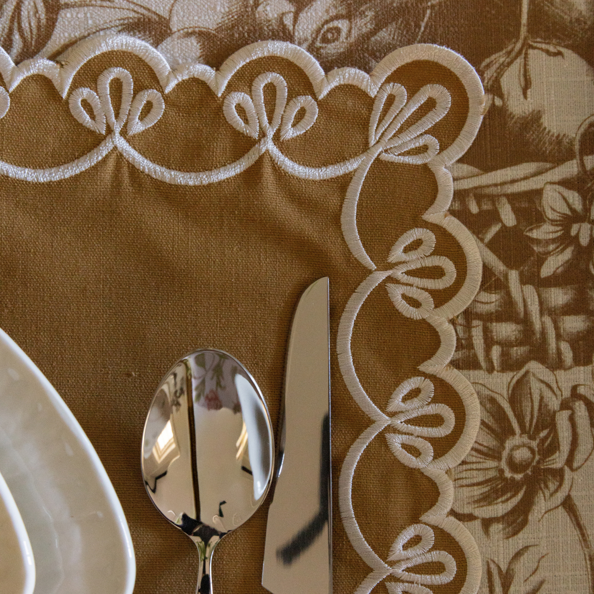 Gold Toile Christmas table styled with gold placemats with ivory embroidery
