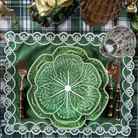 Green and Black Plaid Christmas table styled with green cabbage plates and green placemats with ivory embroidery