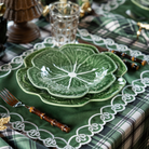 Green and Black Plaid Christmas table styled with green cabbage plates and green placemats with ivory embroidery