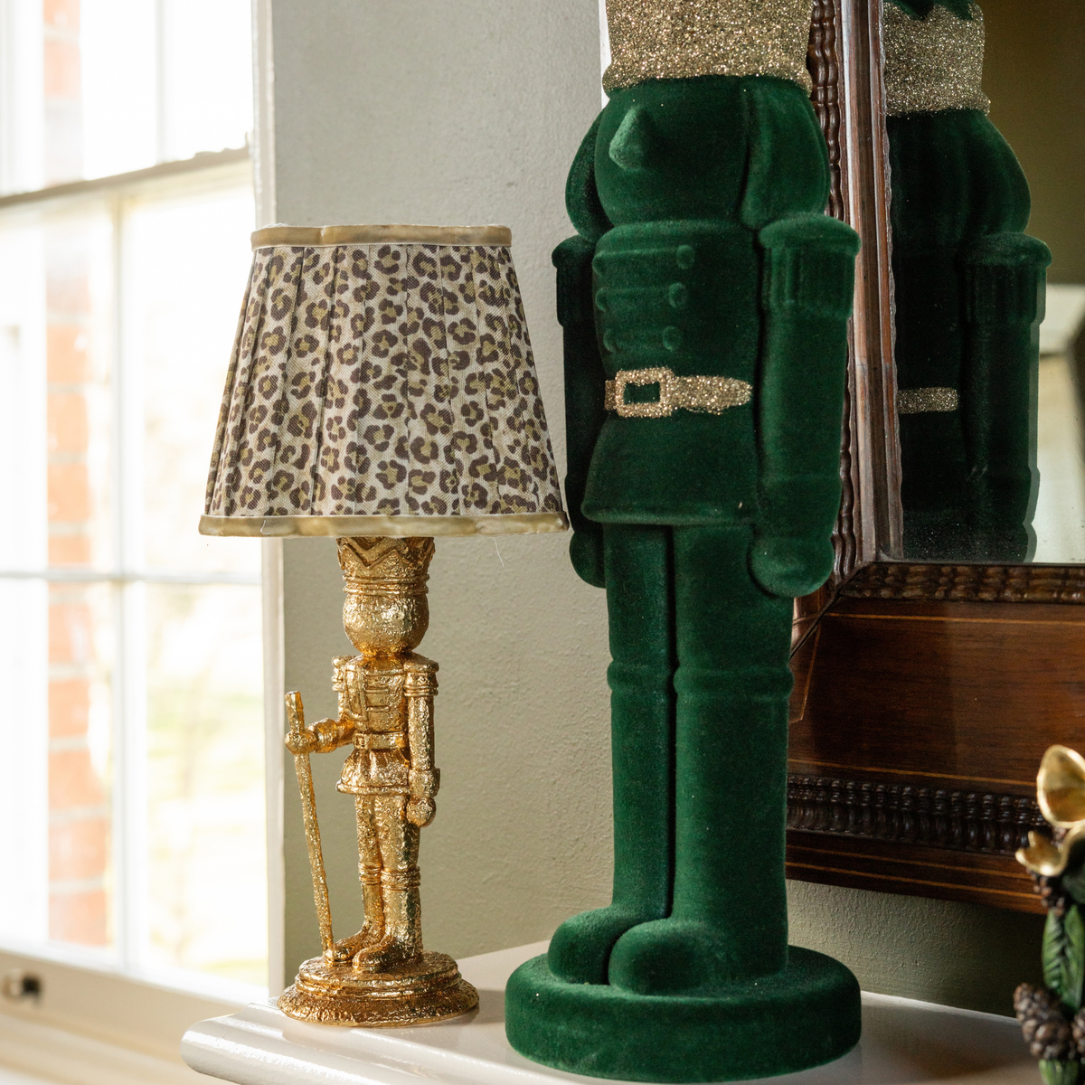 Green and Black Plaid Christmas table styled with gold nutcracker lamp and dark green velvet nutcracker