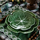 Green and Black Plaid Christmas table styled with green cabbage plates and green placemats with ivory embroidery
