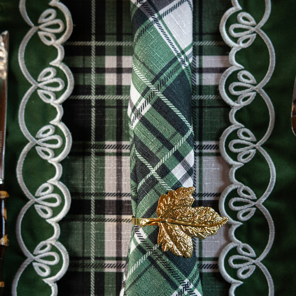 Green and Black Plaid Christmas table styled with gold leaf napkin rings and Green and Black Plaid napkins