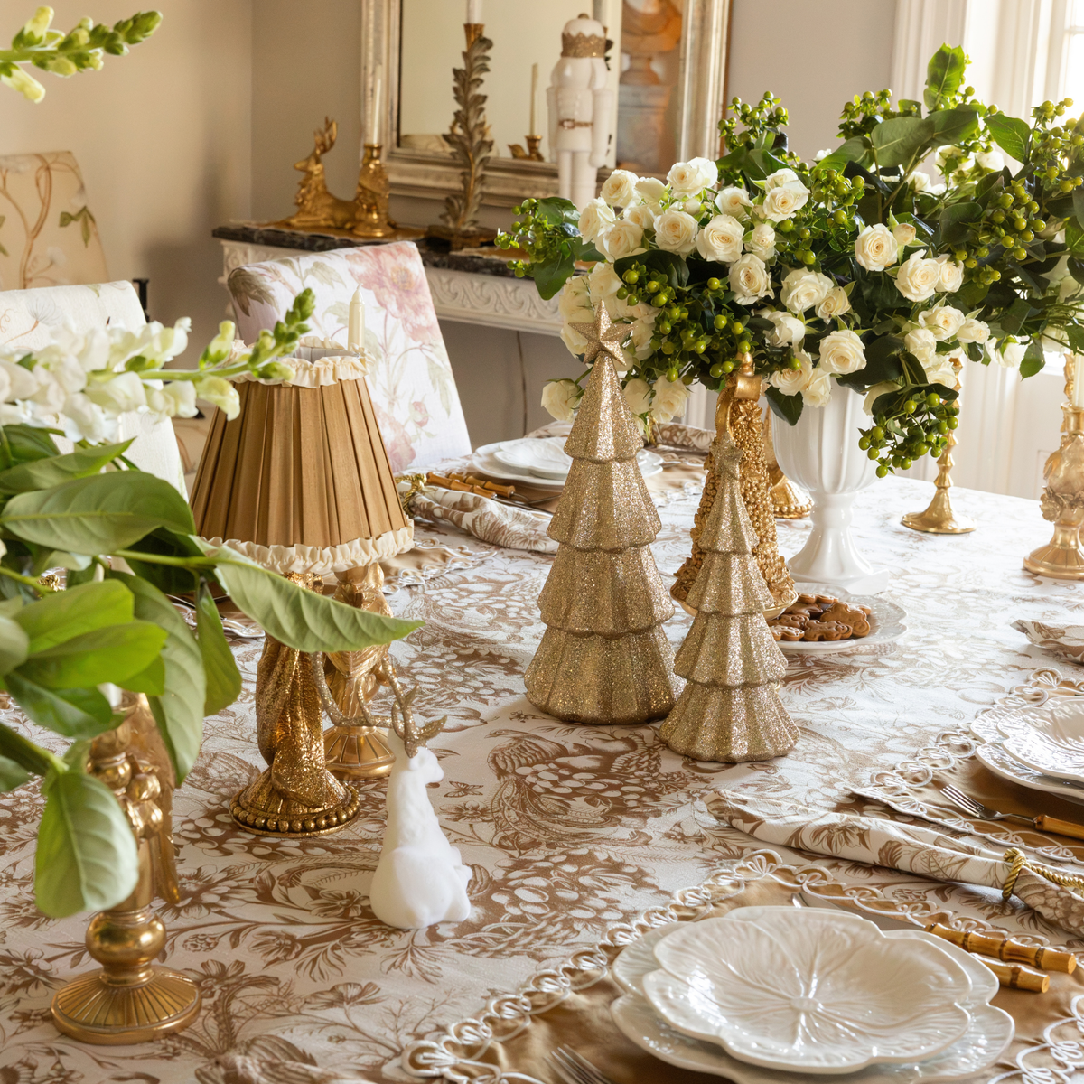 Gold Toile Christmas table styled with Audrey camel and cream shade, cream velvet reindeer and champagne glitter Christmas trees