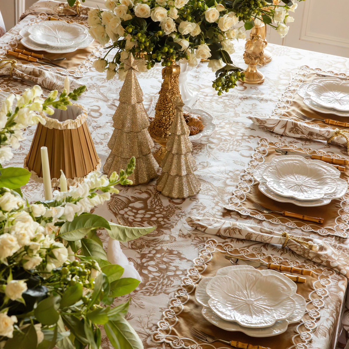 Gold Toile Christmas table styled with champagne glitter Christmas trees and gold Christmas tree