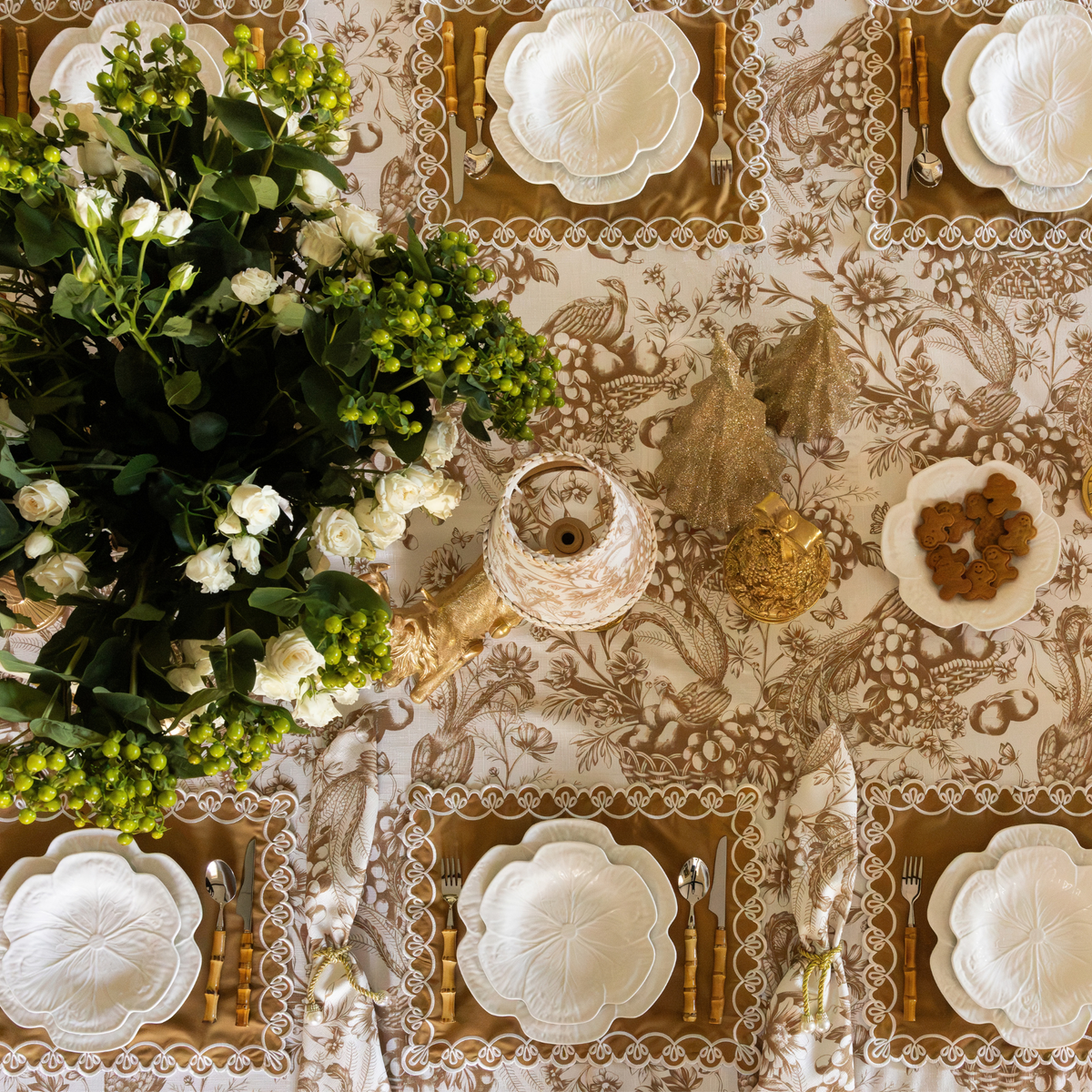 Gold Toile Christmas table styled with white cabbage plates, gold placemats with ivory embroidery and Gold Toile table cloth