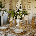 Gold Toile Christmas table styled with gold resting reindeer, gold bird double candle holder and Gold Toile lamp shade