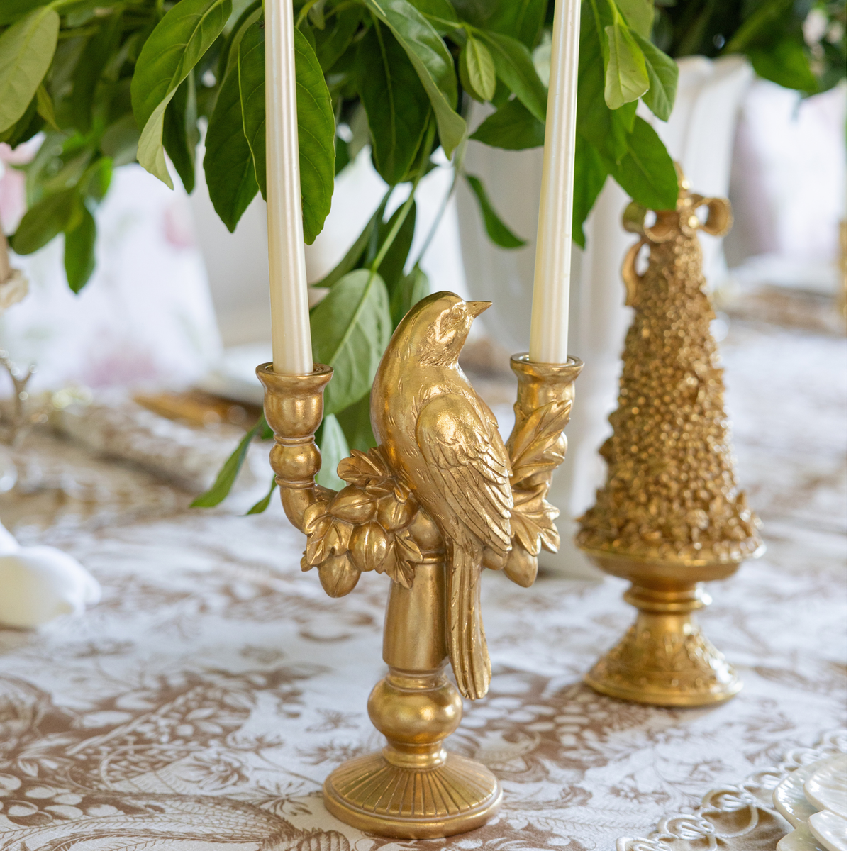 Gold Toile Christmas table styled with gold bird double candle holder and gold Christmas tree
